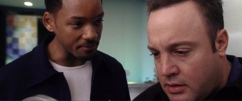 Movie still from “Hitch” (2005), directed by Andy Tennant – Two men looking at each other in a room; Close Up shot, Over the shoulder angle