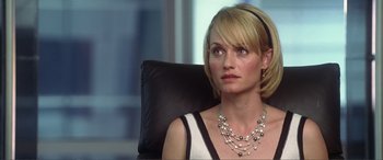 Movie still from “Hitch” (2005), directed by Andy Tennant – A woman sitting in a chair wearing a necklace; Close Up shot, Over the shoulder angle