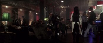 Movie still from “Hitch” (2005), directed by Andy Tennant – A group of people sitting in a dark room; Wide shot, Over the shoulder angle