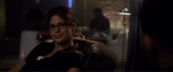 Movie still from “Hitch” (2005), directed by Andy Tennant – A woman wearing glasses sitting in front of a mirror; Close Up shot, Over the shoulder angle