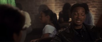 Movie still from “Hitch” (2005), directed by Andy Tennant – A couple of people sitting next to each other in a room; Close Up shot, Over the shoulder angle