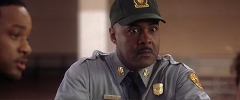 Movie still from “Hitch” (2005), directed by Andy Tennant – A man in a uniform and a hat; Close Up shot, Over the shoulder angle