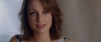 A woman's face with brown hair and green eyes