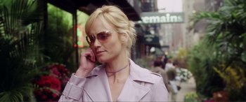 Movie still from “Hitch” (2005), directed by Andy Tennant – A woman wearing sunglasses talking on a cell phone; Close Up shot, Low angle