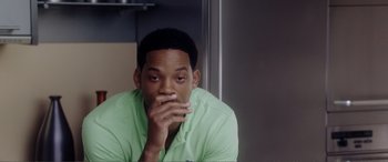 Movie still from “Hitch” (2005), directed by Andy Tennant – A person with his hand to his face; Close Up shot, Over the shoulder angle