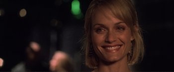 Movie still from “Hitch” (2005), directed by Andy Tennant – A woman smiling for the camera; Close Up shot, Over the shoulder angle