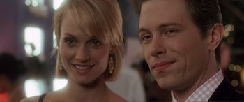 Movie still from “Hitch” (2005), directed by Andy Tennant – A man and a woman smiling for the camera; Close Up shot, Low angle