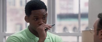 Movie still from “Hitch” (2005), directed by Andy Tennant – A man holding a cell phone up to his face; Close Up shot, Over the shoulder angle