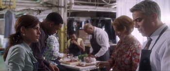 Movie still from “Hitch” (2005), directed by Andy Tennant – A group of people preparing food in a kitchen; Medium shot, Over the shoulder angle