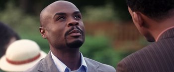 Movie still from “Hitch” (2005), directed by Andy Tennant – A person wearing a suit looking up; Close Up shot, Low angle