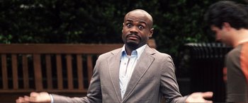 Movie still from “Hitch” (2005), directed by Andy Tennant – A man in a gray jacket and a blue shirt; Close Up shot, Low angle