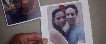 Movie still from “Hitch” (2005), directed by Andy Tennant – A hand holding a photo of a man and a woman; Extreme Close Up shot, Overhead angle