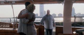 Movie still from “Hitch” (2005), directed by Andy Tennant – A man standing next to two women on a boat; Medium shot, Over the shoulder angle