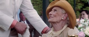 Movie still from “Hitch” (2005), directed by Andy Tennant – An older woman wearing a hat looking up at an older man; Close Up shot, Low angle