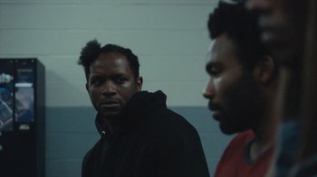 Movie still from “Atlanta” (2016), created by Donald Glover – Two men standing next to each other in a room; Close Up shot, Over the shoulder angle