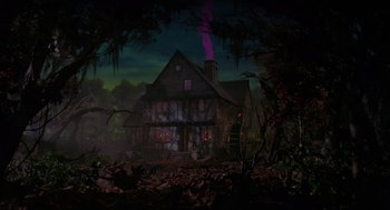 Movie still from “Hocus Pocus” (1993), directed by Kenny Ortega – An image of an old house in the woods at night; Extreme Wide shot, Low angle