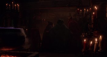Movie still from “Hocus Pocus” (1993), directed by Kenny Ortega – A group of people standing in a dark room; Wide shot, Over the shoulder angle