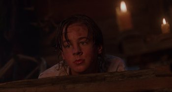 Movie still from “Hocus Pocus” (1993), directed by Kenny Ortega – A young man with dreadlocks is leaning against a wall in the dark; Close Up shot, Low angle