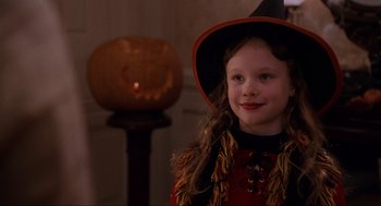 Movie still from “Hocus Pocus” (1993), directed by Kenny Ortega – A little girl in a witch costume standing in front of a pumpkin; Close Up shot, High angle
