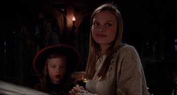 Movie still from “Hocus Pocus” (1993), directed by Kenny Ortega – A woman and a girl in a witch's hat; Close Up shot, High angle