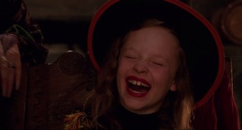Movie still from “Hocus Pocus” (1993), directed by Kenny Ortega – A young girl wearing a witch's hat and laughing; Close Up shot, High angle