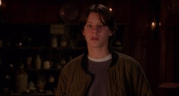 Movie still from “Hocus Pocus” (1993), directed by Kenny Ortega – A man in a brown jacket is standing in a room; Close Up shot, Low angle