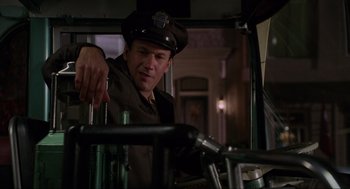 Movie still from “Hocus Pocus” (1993), directed by Kenny Ortega – A man wearing a hat standing next to a bicycle; Medium shot, Low angle