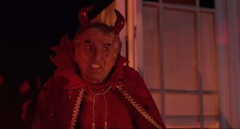 Movie still from “Hocus Pocus” (1993), directed by Kenny Ortega – An older man dressed as a devil for halloween; Medium shot, Low angle