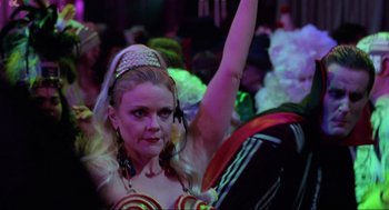 Movie still from “Hocus Pocus” (1993), directed by Kenny Ortega – A woman in a carnival costume is raising her hand; Close Up shot, Low angle