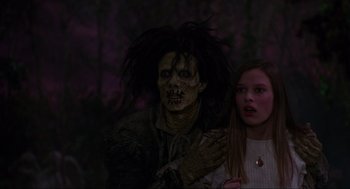 Movie still from “Hocus Pocus” (1993), directed by Kenny Ortega – A woman standing next to a man in a costume; Medium shot, Over the shoulder angle