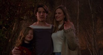 Movie still from “Hocus Pocus” (1993), directed by Kenny Ortega – A man and a woman standing next to a little girl; Medium shot, Low angle