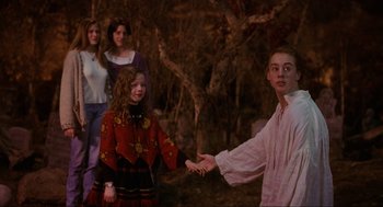 Movie still from “Hocus Pocus” (1993), directed by Kenny Ortega – A group of people standing in the woods holding hands; Medium shot, Over the shoulder angle