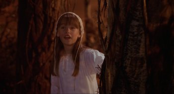 Movie still from “Hocus Pocus” (1993), directed by Kenny Ortega – A girl in a white dress standing next to a tree; Medium shot, High angle