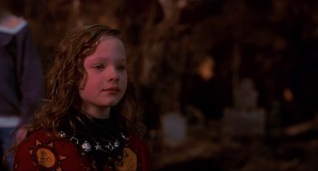 Movie still from “Hocus Pocus” (1993), directed by Kenny Ortega – A little girl with long hair wearing a necklace; Close Up shot, Over the shoulder angle
