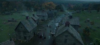 Movie still from “Hocus Pocus 2” (2022), directed by Anne Fletcher – An aerial view of people walking on a path in a village; Extreme Wide shot, High angle