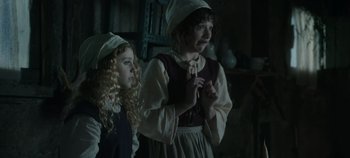 Movie still from “Hocus Pocus 2” (2022), directed by Anne Fletcher – Two young girls dressed in medieval clothing standing next to each other; Medium shot, Over the shoulder angle