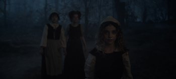 Movie still from “Hocus Pocus 2” (2022), directed by Anne Fletcher – A group of young people in costumes in a dark forest; Medium shot, Low angle