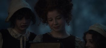 Movie still from “Hocus Pocus 2” (2022), directed by Anne Fletcher – A woman with curly red hair is looking at a tablet; Close Up shot, Low angle
