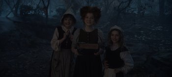 Movie still from “Hocus Pocus 2” (2022), directed by Anne Fletcher – Three children dressed up in costumes in the woods; Medium shot, High angle
