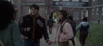 Movie still from “Hocus Pocus 2” (2022), directed by Anne Fletcher – A boy and a girl holding hands while walking down a street; Medium shot, Over the shoulder angle