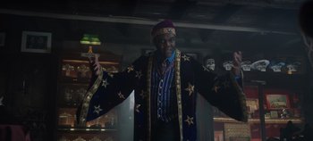 Movie still from “Hocus Pocus 2” (2022), directed by Anne Fletcher – A man in a costume standing in front of a wall; Medium shot, Low angle