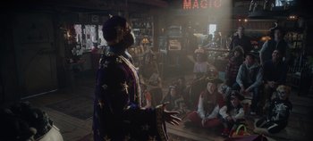 Movie still from “Hocus Pocus 2” (2022), directed by Anne Fletcher – A man that is dressed up as a wizard; Medium shot, Over the shoulder angle