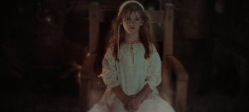 Movie still from “Hocus Pocus 2” (2022), directed by Anne Fletcher – A young girl in a white dress sitting in a chair; Medium shot, High angle
