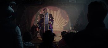 Movie still from “Hocus Pocus 2” (2022), directed by Anne Fletcher – A man wearing a purple and gold robe and a purple hat; Wide shot, Over the shoulder angle