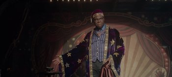 Movie still from “Hocus Pocus 2” (2022), directed by Anne Fletcher – A man wearing a purple robe and a purple hat; Medium shot, Low angle