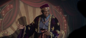 Movie still from “Hocus Pocus 2” (2022), directed by Anne Fletcher – A man dressed as a king holding a red purse; Medium shot, Low angle