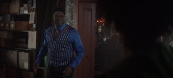 Movie still from “Hocus Pocus 2” (2022), directed by Anne Fletcher – A man standing in front of a doorway; Medium shot, Over the shoulder angle