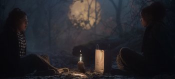 Movie still from “Hocus Pocus 2” (2022), directed by Anne Fletcher – A candle lit in the middle of the woods; Wide shot, Low angle