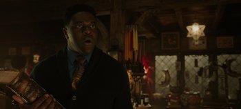 Movie still from “Hocus Pocus 2” (2022), directed by Anne Fletcher – A man in a suit and tie in a room; Medium shot, Low angle