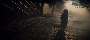 Movie still from “Hocus Pocus 2” (2022), directed by Anne Fletcher – A person walking down a street at night; Extreme Wide shot, High angle